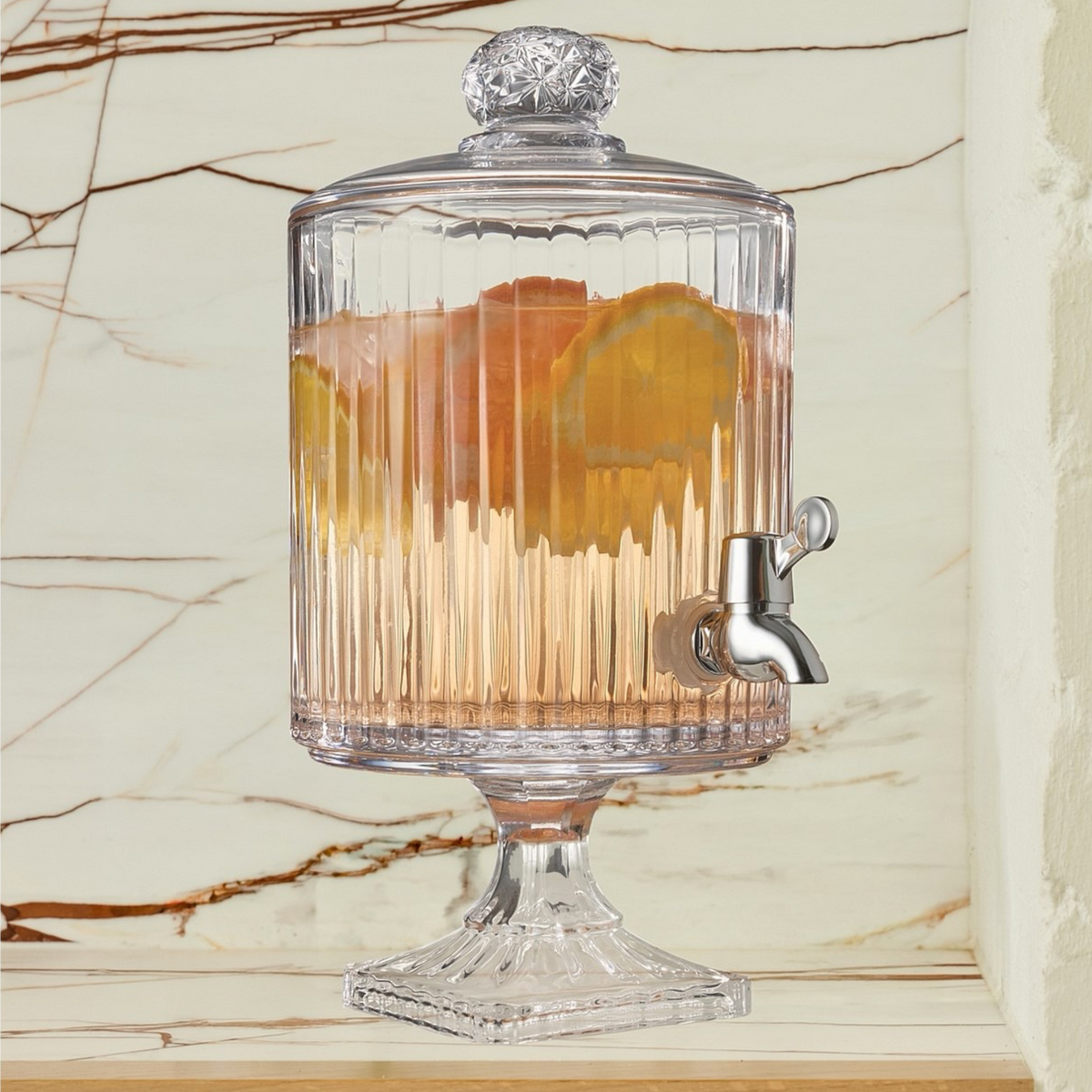 Artika Rockland 3L glass dispenser filled with iced drink, lifestyle shot on marble