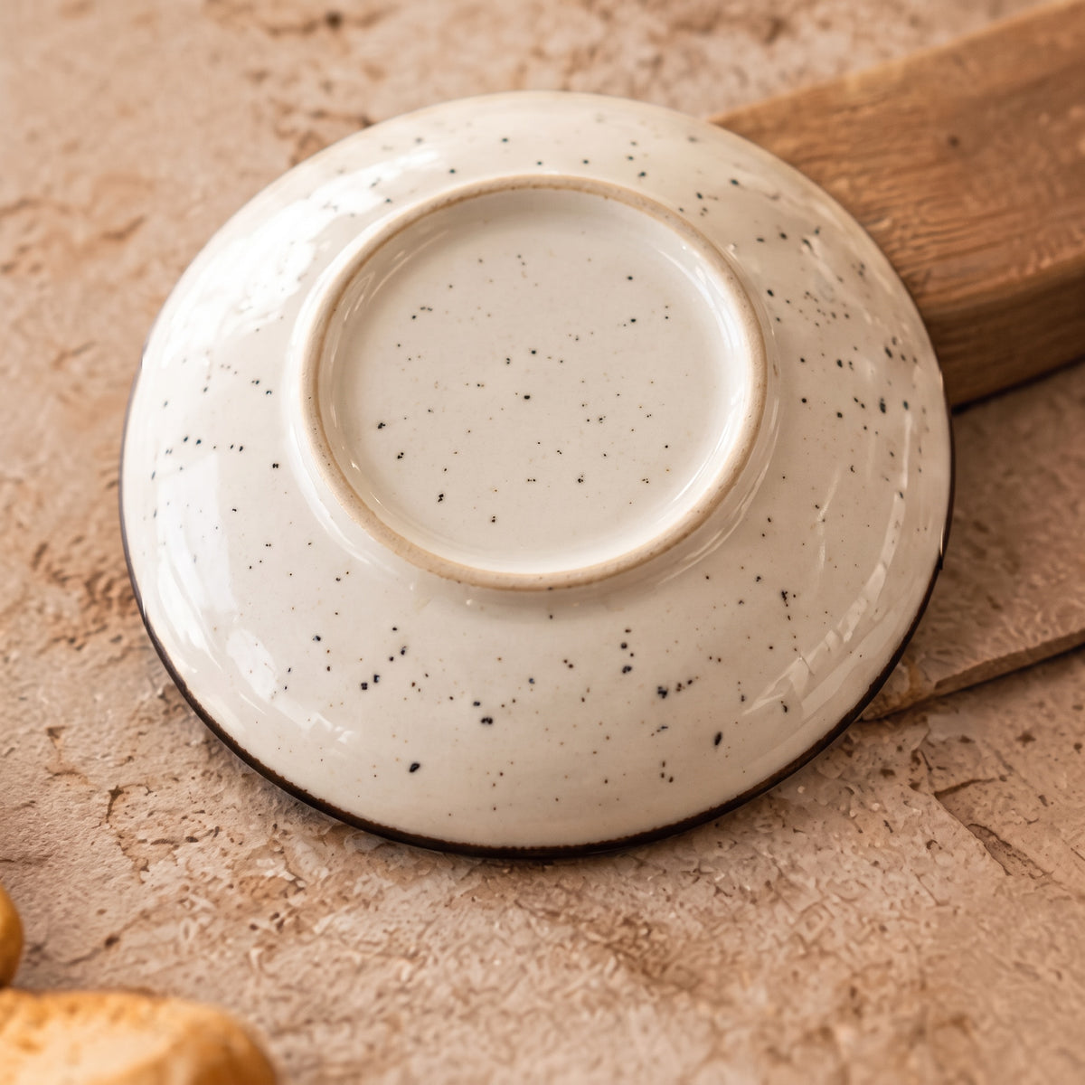 Terra Charcoal stoneware saucer underside, speckled glaze detail