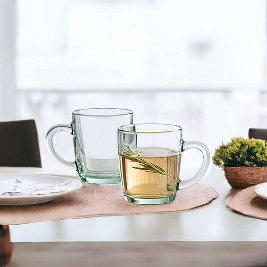 Pasabahce clear glass handled mugs — set of 12, one filled with herbal tea and rosemary on dining table, IKIDO Canada